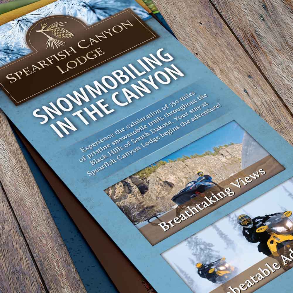 Spearfish Canyon Lodge rack cards on a wooden table